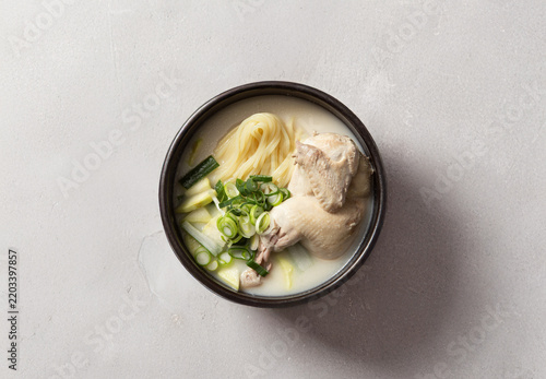 Korean chicken soup with noodles known as Samgyetang in earthenware pot