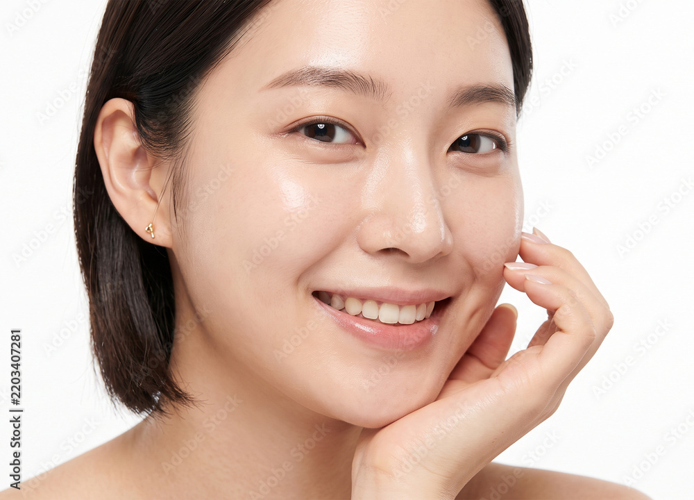 Obraz premium Close up portrait of a cheerful young Asian woman smiling on white background