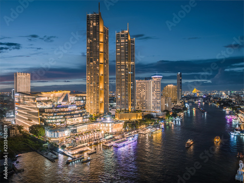 Aerial night view of the skyline along the Chao Phraya River, Bangkok, Thailand