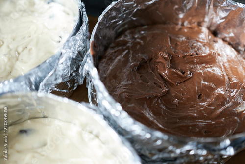 Chocolate batter in a baking pan. Selective focus. Preparing a cake.
