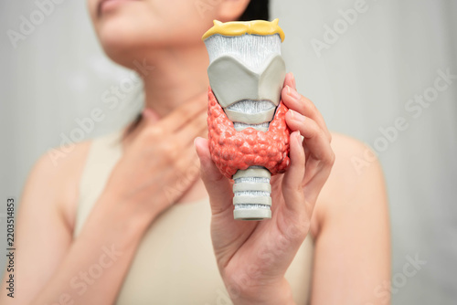 Hyperthyroidism, Overactive Thyroid, Thyroid Lymphoma, Asian woman with thyroid gland human anatomy model.