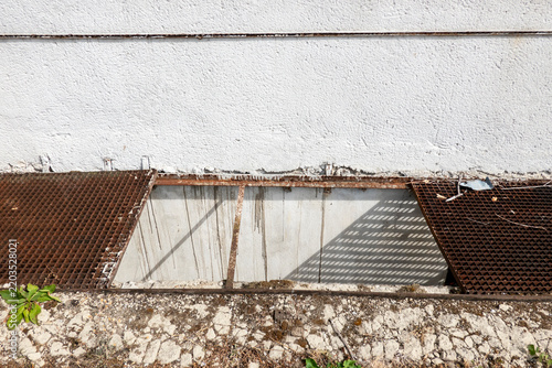 Missing section of metal grating flooring for safe passage over the floor shaft.