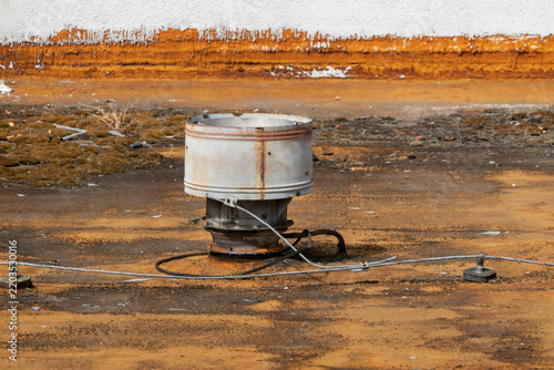 Ventilation unit on the unmaintained roof of an old building