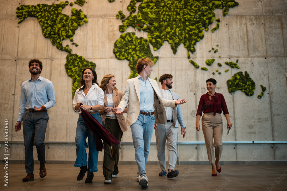 Fototapeta premium Diverse business team walking global map office building