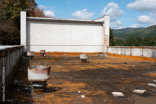 Ventilation unit on the unmaintained roof of an old building