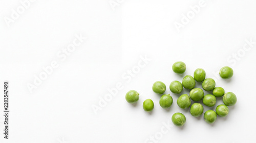 Fresh Green Peas Scattered on a Plain White Background