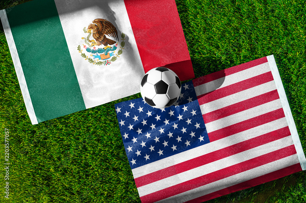 Obraz premium Mexico vs. United States of America football match. National flags on green grass with soccer ball in the middle. Football background for international match.
