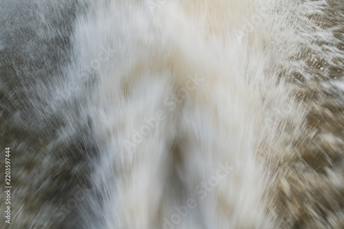 Fotografie Abstract close up view of fast moving white water spray and motion blur splash