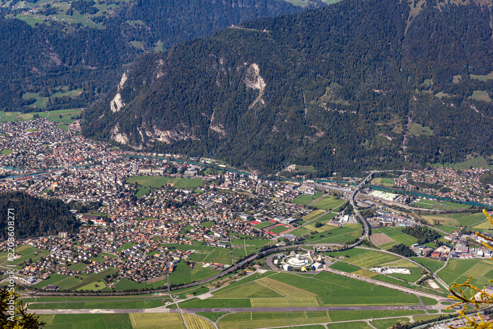 Obraz premium Top view from Schynige Platte over Swiss Alps town Interlaken with the permanently closed amusement Jungfrau Park,