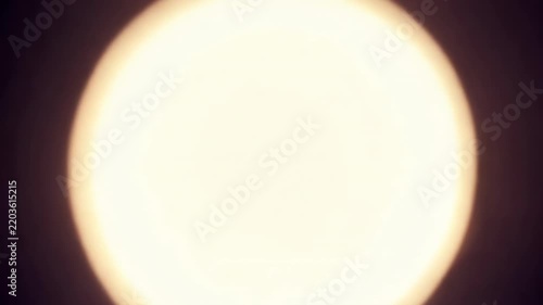 Abstract animation of blue and golden glowing particles swirling toward a bright central light, creating a dynamic tunnel effect on black background, digital motion graphic