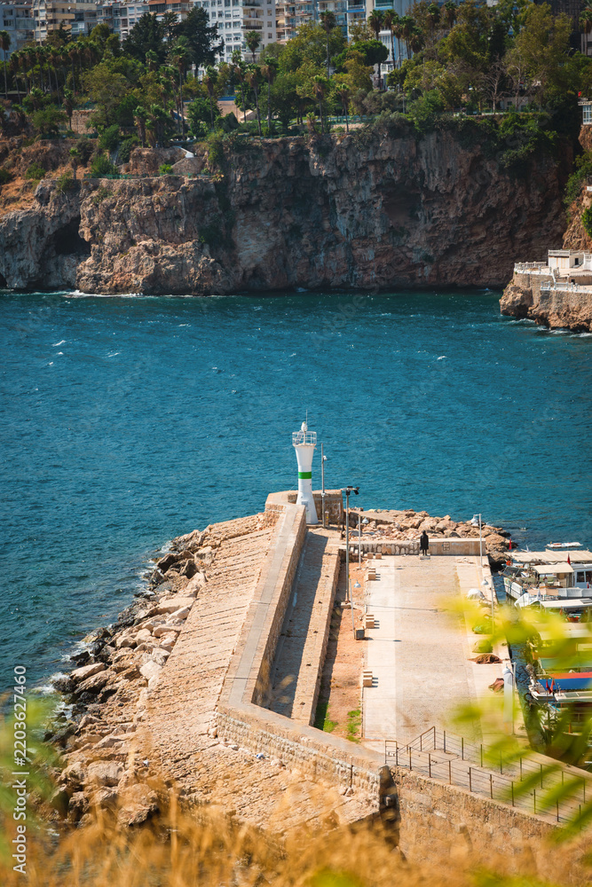 Obraz premium Breakwater lighthouse at Kaleici Old Harbor in Antalya on the Mediterranean coast
