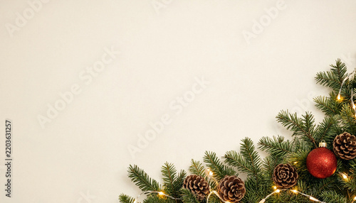 Christmas background with fir branches, pine cones, red bauble and fairy lights