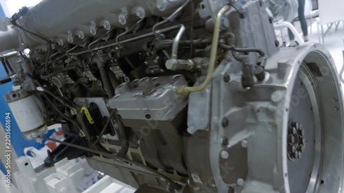 A new modern internal combustion engine for a truck is presented at the exhibition. Closeup. Shot in motion