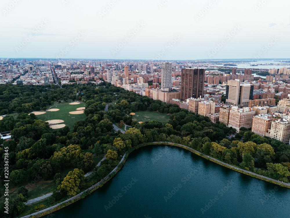 Fototapeta premium Aerial view of Central Park surrounded by Manhattan skyscrapers and New York City skyline.