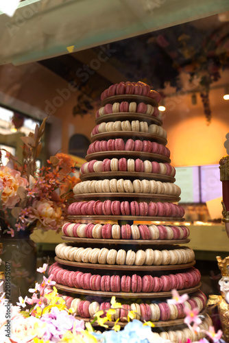 Elegant pastry shop storefront featuring colorful macaron towers and artisan desserts