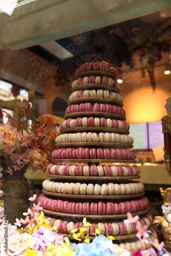 Elegant pastry shop storefront featuring colorful macaron towers and artisan desserts