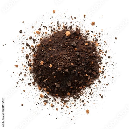 Dark ground coffee grounds pile with scattered coarse pieces isolated on white background.