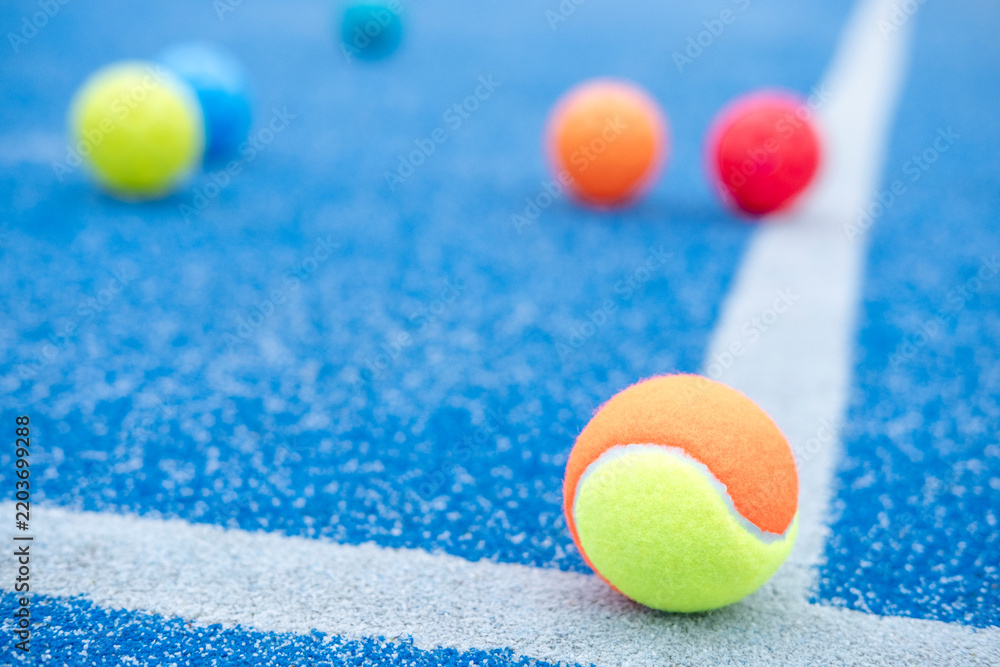 Fototapeta premium Two tone padel ball on blue turf court The Concept of sports competition