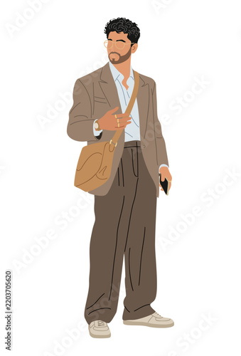 Casual businessman stands confidently with a messenger bag slung across his shoulder. He wears a light blazer, loose trousers, and white sneakers. His dark, curly hair and beard add a stylish