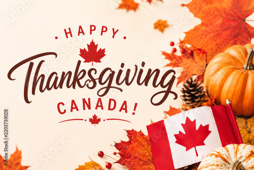 Holiday background for Canadian Thanksgiving with autumn harvest, pumpkins and flag. Top view.