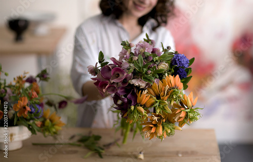 Floral arrangement with calla lilies and alstroemeria is displayed by a blurred florist bouquet flowers callalily blossom bloom petal flora botanical composition floraldesign workshop studio