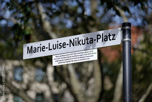 Cologne, Germany September 23 2026: Street sign of Marie-Luise-Nikuta-Platz with explanatory plaque near Rudolfplatz in Cologne's city center, Germany
