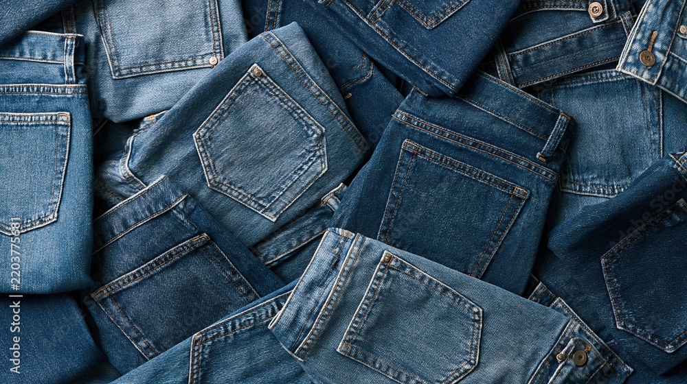 Fototapeta premium Stacked blue denim jeans with back pockets