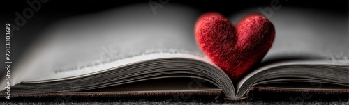A close up of a book with a red heart on it love background banner copy space
