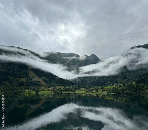 Misty fjord valley with low clouds and reflections near Balestrand, Vestland, Norway, August 2025
