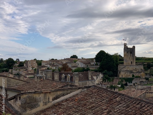 Historic stone village Saint-Émilion with church tower under clouds, Libourne, Nouvelle-Aquitaine, France, September 2022