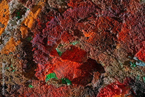 Multicolor peeling graffiti paint texture on old Soviet avant-garde constructivism building wall with vibrant cracked layers