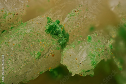 Photomicrography of vibrant green bayldonite micro crystals on striated faces of columnar quartz under 10x microscope