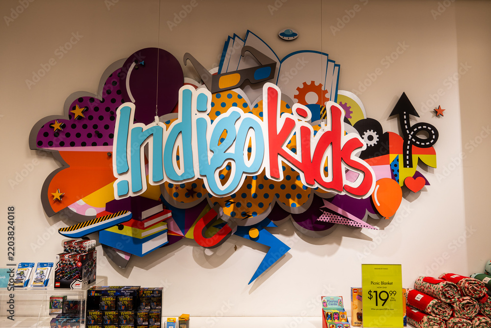 Naklejka premium Toronto, Canada - June 18, 2026: Indigo Kids section with colorful sign and books on display