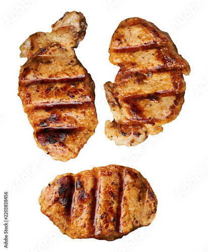 Three appetizing grilled pork steaks with grill marks