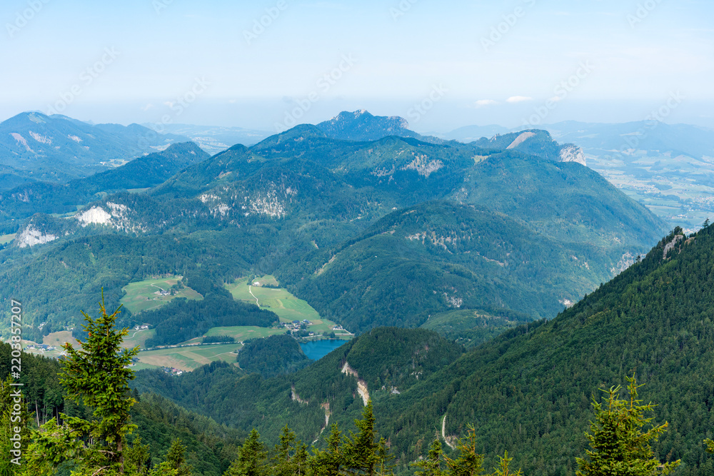 Fototapeta premium Aerial view of mountain landscape. Landscape panorama. Misty landscape with mountain lake in nature. Mountain peak aerial view. Aerial misty landscape. Scenic nature over lake