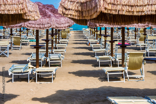 Pescara Beach Club With Thatched Umbrellas And Empty Sunbeds