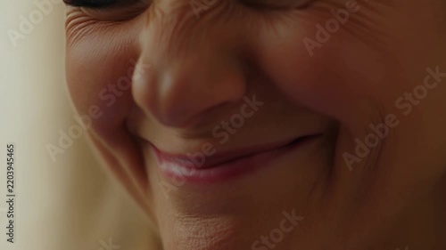 Warm smile lights up her face. Genuine joy creases her skin. Soft focus captures a tender moment. Perfect for heartwarming lifestyle scenes