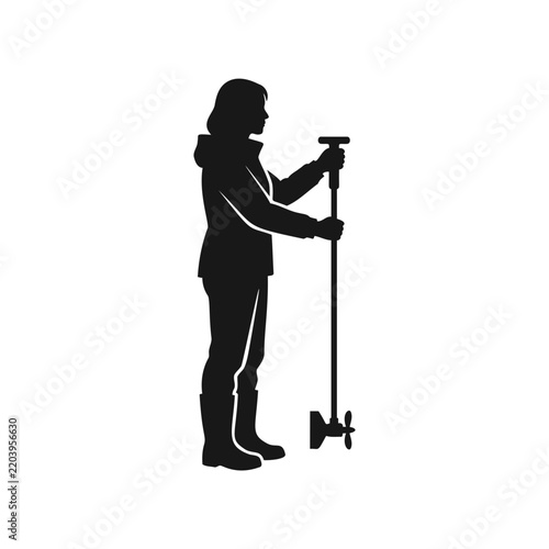 A woman stands upright holding a manual water turbidity measurement probe tool