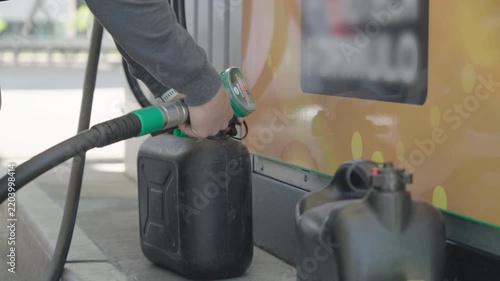 Filling-up the fuel container at gas station close-up
