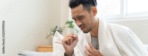 Close-up young men seriously coughing and has chest pain from lung cancer.