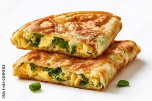 Indonesian folded egg omelet with crispy green onion filling on white background