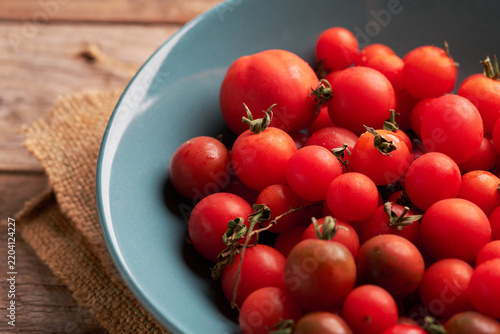 Fresh Cherry Tomatoes in a Blue Bowl on a Wooden Table