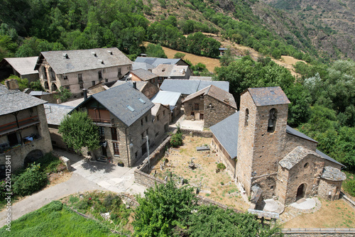 Aerial view of the historic Romanesque church of Sant Pere de Sorpe in Alt Àneu on sunny summer day. Lleida, Catalonia, Spain.