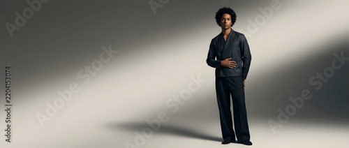 Black man, fashion and portrait with suit in studio for clothing brand, advertising and marketing campaign. Male model, luxury and outfit with designer style, elegant apparel and minimalist look