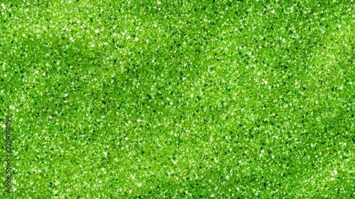 Macro texture of bright green slime mixed with sparkling glitter
