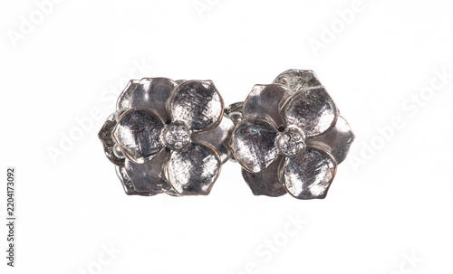 Fotografie Silver flower brooch isolated on a white background.
