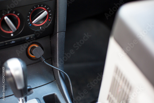 Fotografie Car interior featuring a close-up of a charging port with a connected cable, gea