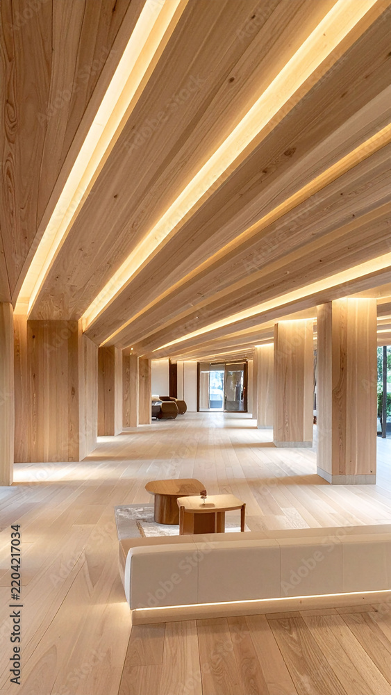 Obraz premium Modern luxury hotel lounge interior featuring warm wooden ceiling beams, ambient linear lighting, and elegant decor. There are no people in this serene architectural space.