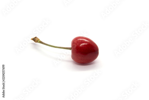Fotografie Red berry of a cherry tree on a white background