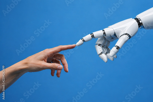 A robot's hand and a human hand—an allusion to Michelangelo. Creator and human. Robot and human.